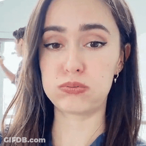 A Woman Is Making A Funny Face With Her Mouth Open . GIF