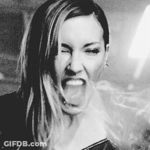 A Woman Is Making A Funny Face With Her Mouth Open GIF