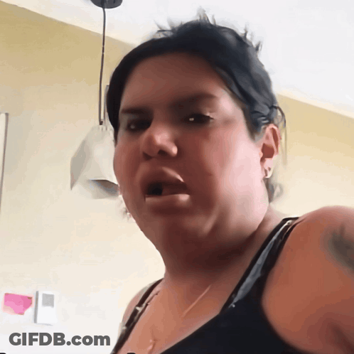 A Woman Is Making A Funny Face With Her Mouth Open GIF