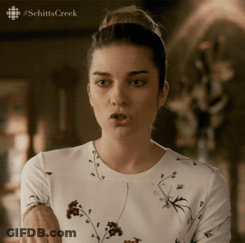 A Woman Is Making A Funny Face With #Schitts Creek Written On The Bottom GIF