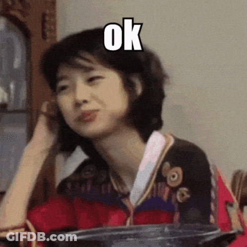 A Woman Is Making A Funny Face With The Word Ok Above Her GIF