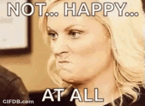 A Woman Is Making A Funny Face With The Words `` Not Happy At All '' Written On Her Face . GIF