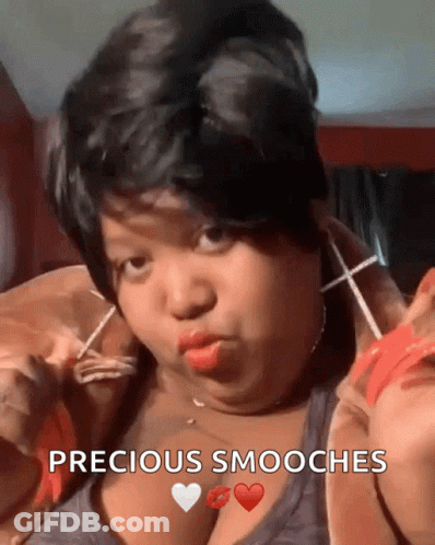 A Woman Is Making A Funny Face With The Words Precious Smooches In The Corner GIF