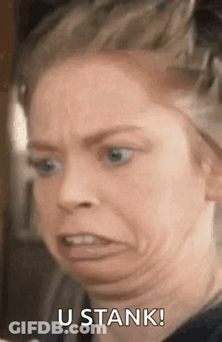 A Woman Is Making A Funny Face With The Words `` U Stank '' Written Next To Her . GIF