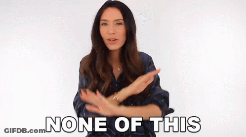 A Woman Is Making A Gesture With Her Hands And The Words None Of This Are Behind Her . GIF