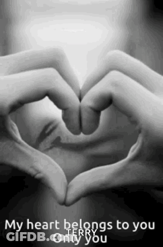 A Woman Is Making A Heart Shape With Her Hands . GIF