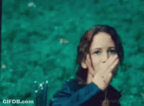A Woman Is Making A Peace Sign With Her Hand In The Water . GIF