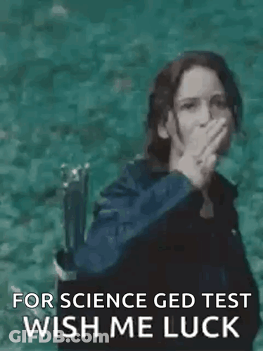 A Woman Is Making A Peace Sign With Her Hand While Standing In The Water . GIF
