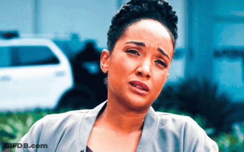 A Woman Is Making A Sad Face In Front Of A Police Car GIF