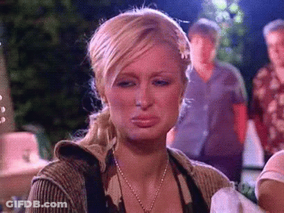 A Woman Is Making A Sad Face While Holding A Baby . GIF