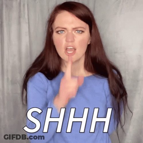 A Woman Is Making A Shhh Sign With Her Finger To Her Mouth . GIF