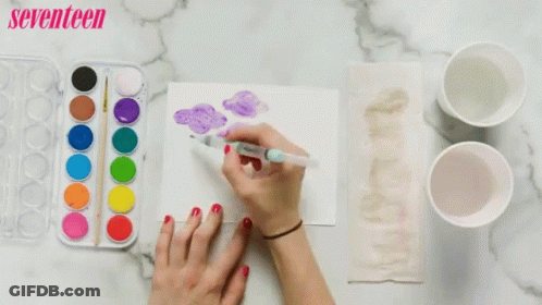 A Woman Is Painting A Picture With Watercolors And A Seventeen Logo In The Background GIF