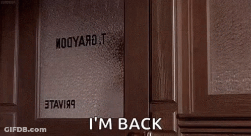 A Woman Is Peeking Out Of A Door And Saying `` I 'M Back '' While Holding A Book . GIF