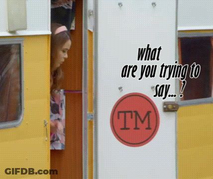 A Woman Is Peeking Out Of A Yellow Trailer With A Tm Sticker On The Door GIF