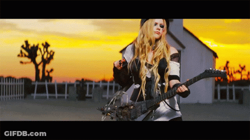 A Woman Is Playing A Guitar In Front Of A White House GIF