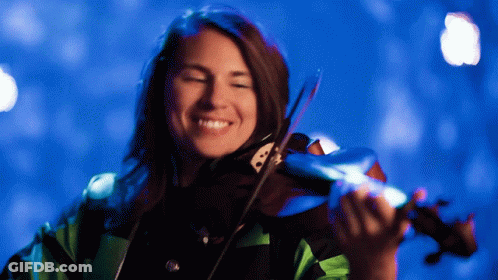 A Woman Is Playing A Violin In Front Of A Blue Background GIF