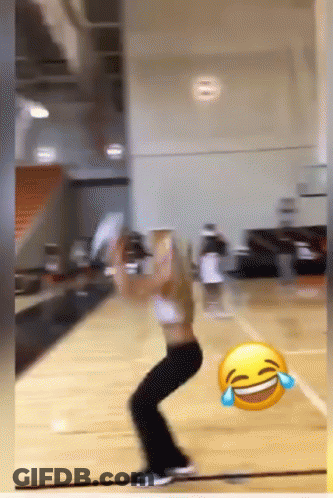 A Woman Is Playing Basketball With A Laughing Face In The Foreground GIF