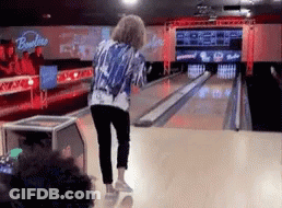 A Woman Is Playing Bowling In A Bowling Alley With A Sign That Says Bowlline GIF