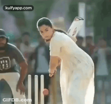 A Woman Is Playing Cricket With A Bat And Ball . GIF