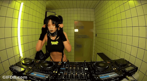 A Woman Is Playing Music On A Pioneer Dj Setup GIF