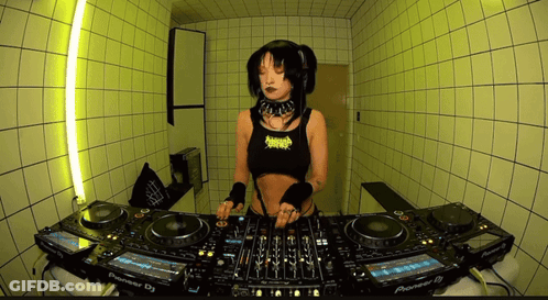 A Woman Is Playing Music On A Pioneer Dj Setup GIF