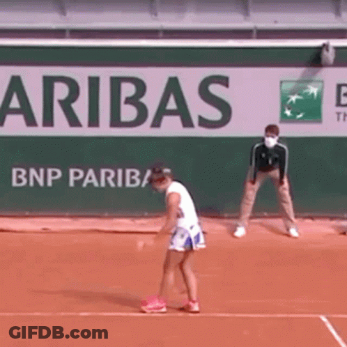 A Woman Is Playing Tennis On A Court In Front Of A Bnp Paribas Sign . GIF