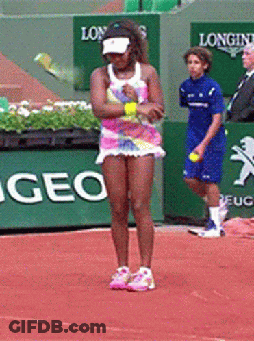 A Woman Is Playing Tennis On A Court With A Longines Sign In The Background GIF