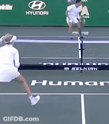 A Woman Is Playing Tennis On A Court With An Ad For Franklin Hyundai Behind Her GIF