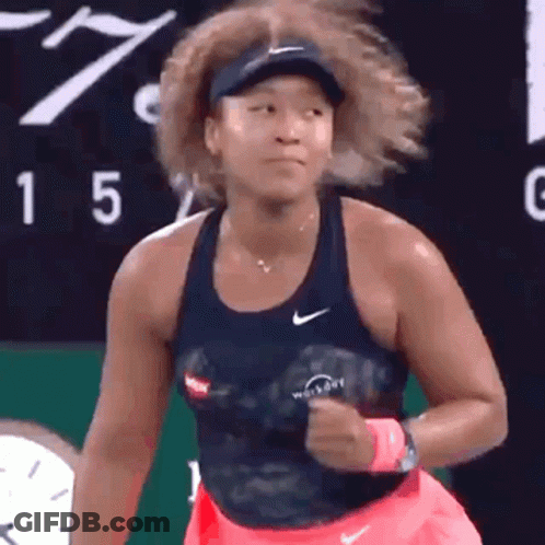 A Woman Is Playing Tennis On A Tennis Court . GIF