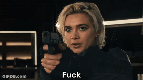 A Woman Is Pointing A Gun At The Camera And Saying " You " . GIF