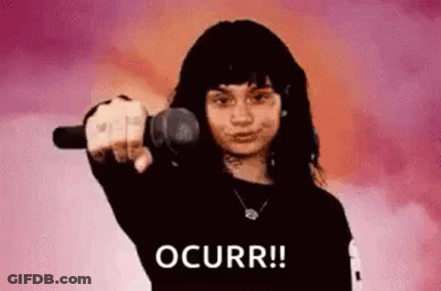 A Woman Is Pointing At The Camera With A Microphone . GIF