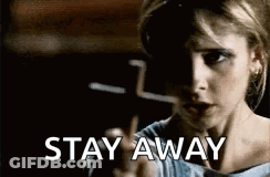 A Woman Is Pointing At The Camera With The Words `` Stay Away '' Written Below Her . GIF