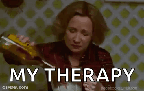 A Woman Is Pouring A Drink Into A Glass With The Words My Therapy Written Below Her GIF