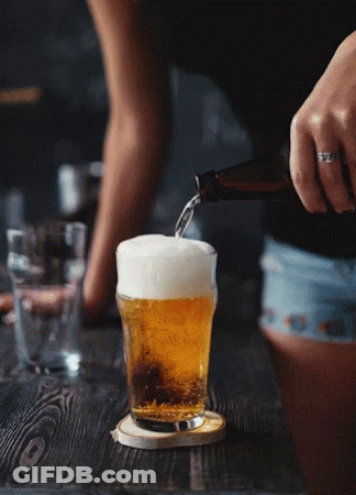 A Woman Is Pouring Beer Into A Glass On A Table GIF