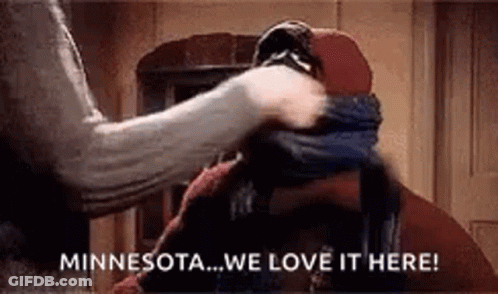 A Woman Is Putting A Scarf Around A Man 'S Face . GIF