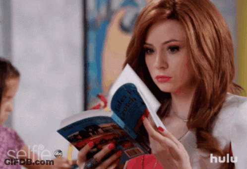 A Woman Is Reading A Book Titled Tales From A Witch GIF