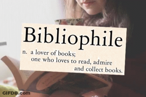 A Woman Is Reading A Book While Holding A Sign That Says Bibliophile GIF