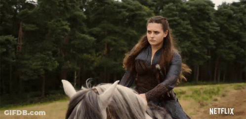 A Woman Is Riding A Horse In A Field With Netflix Written On The Bottom Of The Screen GIF
