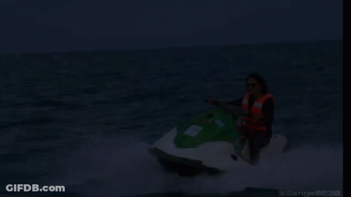 A Woman Is Riding A Jet Ski In The Ocean With The Words On My Way Written Below Her GIF