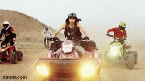 Woman Riding Pink Polaris ATV In Desert GIF