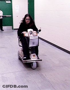 A Woman Is Riding A Scooter That Has The Number 7 On It GIF