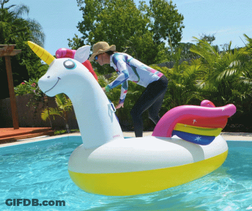 A Woman Is Riding On An Inflatable Unicorn In A Swimming Pool GIF