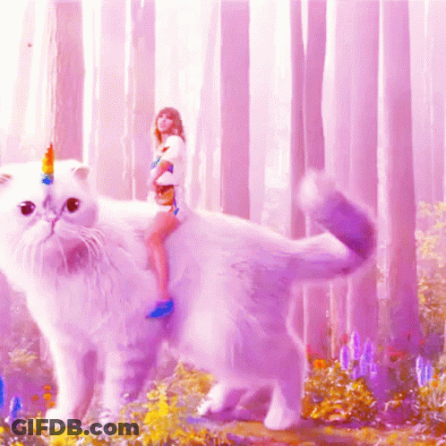 A Woman Is Riding On The Back Of A White Cat With A Unicorn Horn On Its Head GIF