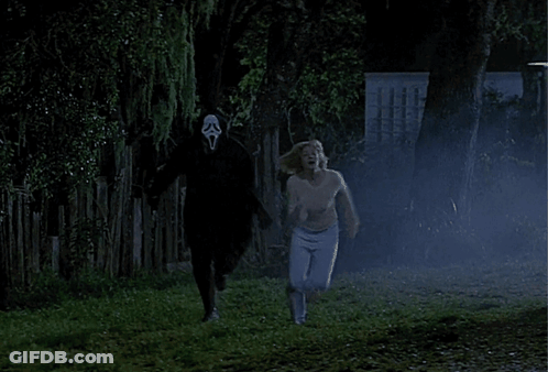 A Woman Is Running Away From A Man With A Scream Mask On His Face GIF
