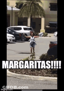 A Woman Is Running In A Parking Lot With A Sign That Says Margaritas GIF
