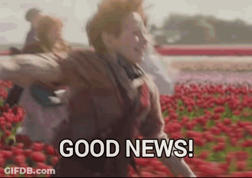 A Woman Is Running Through A Field Of Red Flowers And Says `` Good News '' . GIF