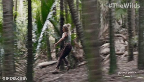 A Woman Is Running Through A Forest In A Prime Video Ad GIF