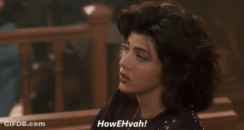 A Woman Is Saying Howehvah In A Dark Room GIF