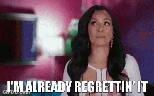 A Woman Is Saying `` I 'M Already Regrettin ' It '' While Standing In A Pink Room . GIF