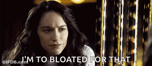 A Woman Is Saying `` I 'M To Bloated For That '' In Front Of A Ferris Wheel . GIF